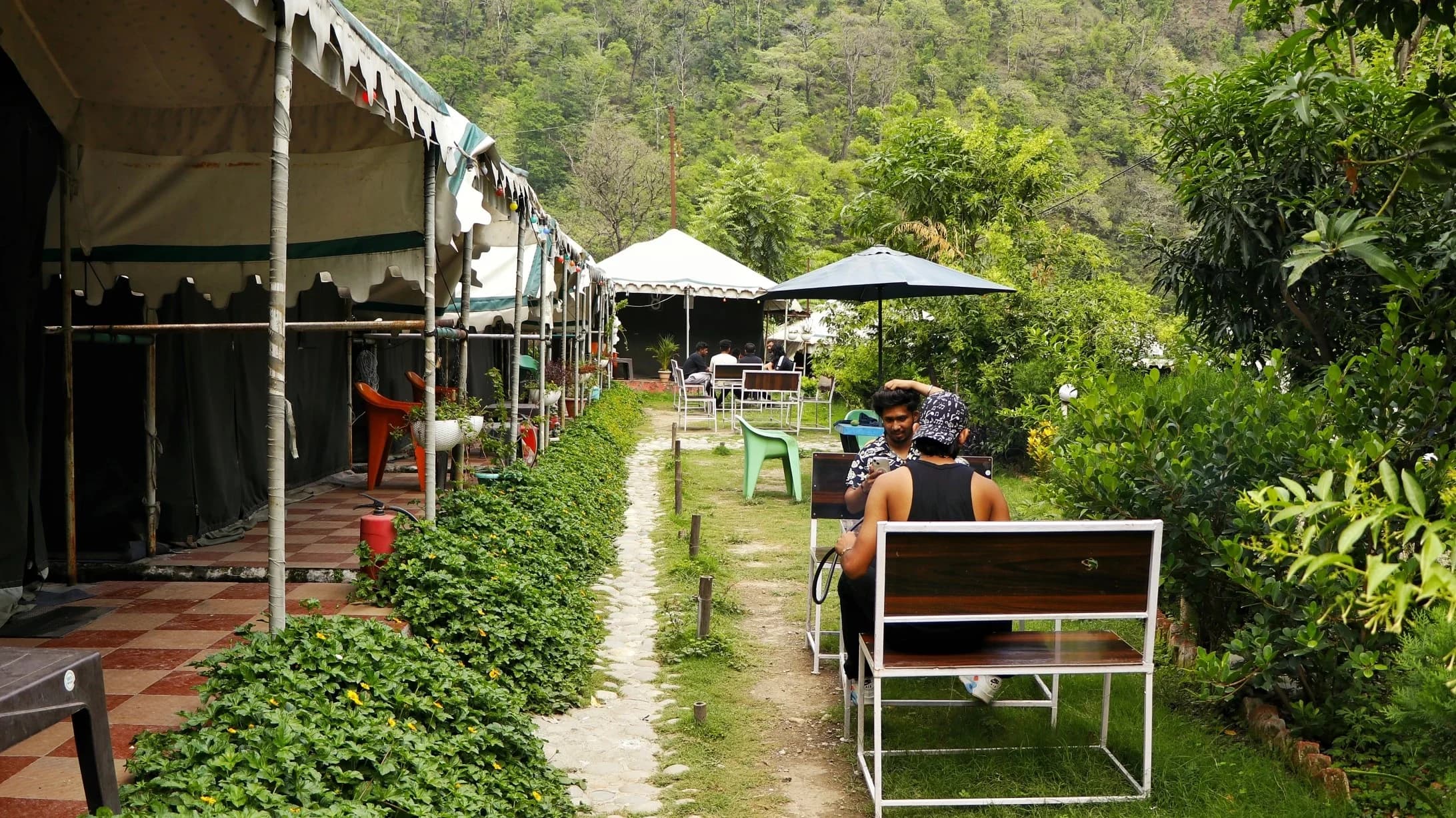 Open-air buffet dining and gardens at Tapovan Swiss Camps